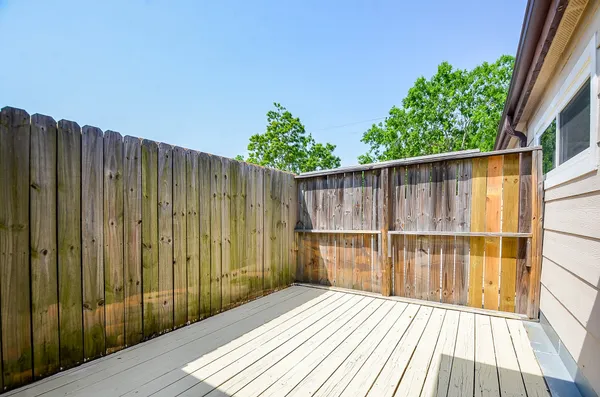 a view of balcony with wooden floor