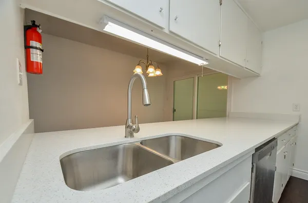 a kitchen with a sink and a refrigerator