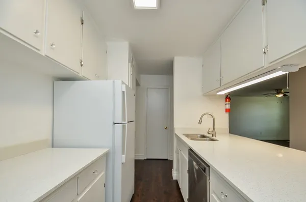 a kitchen with a sink a stove and refrigerator