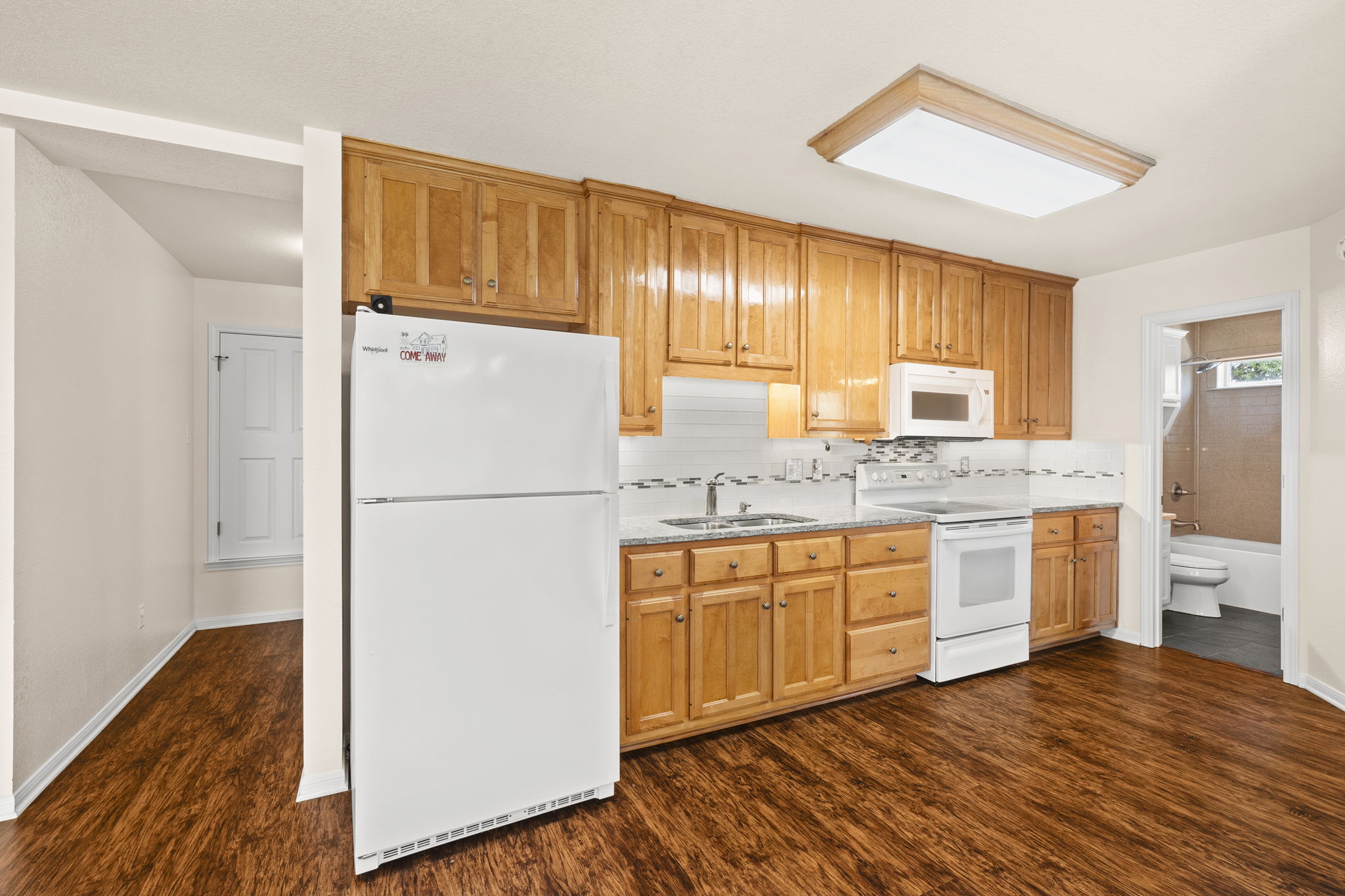 1427 River Ridge Ranch Road Killeen, TX 76549 - Photo 21 of 40 Downstairs, a functional kitchen boasts warm wood cabinetry and durable countertops, ready for daily living.