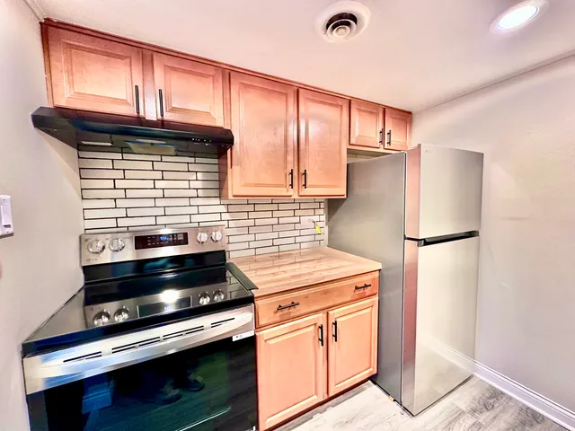 a kitchen with appliances and cabinets