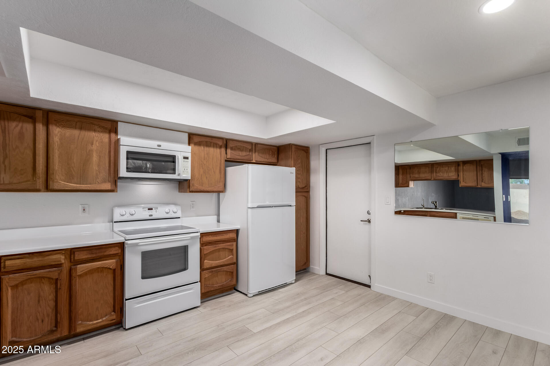 716 West Boxelder Place Chandler, AZ 85225 - Photo 2 of 15 a kitchen with stainless steel appliances granite countertop a stove top oven a sink dishwasher and a refrigerator with wooden floor