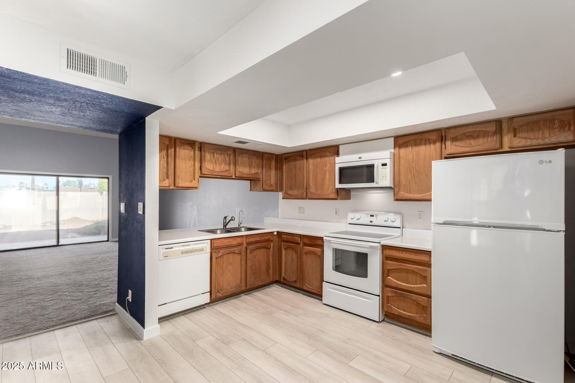 716 West Boxelder Place Chandler, AZ 85225 - Photo 4 of 15 a kitchen with stainless steel appliances granite countertop a refrigerator a stove a sink and white cabinets