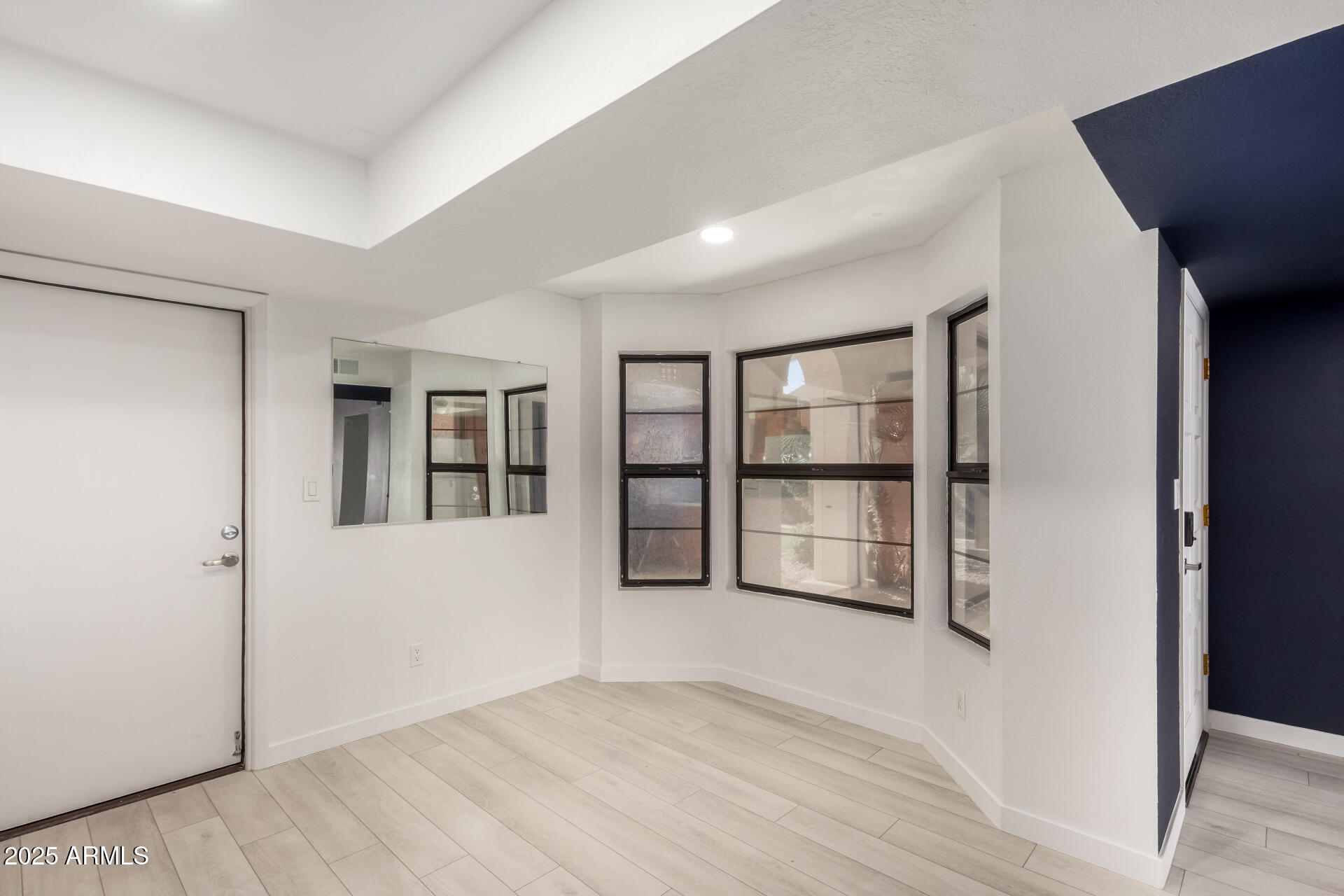716 West Boxelder Place Chandler, AZ 85225 - Photo 6 of 15 a view of an empty room with wooden floor and door