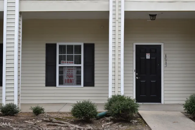 a view of a window of a house with potted plants