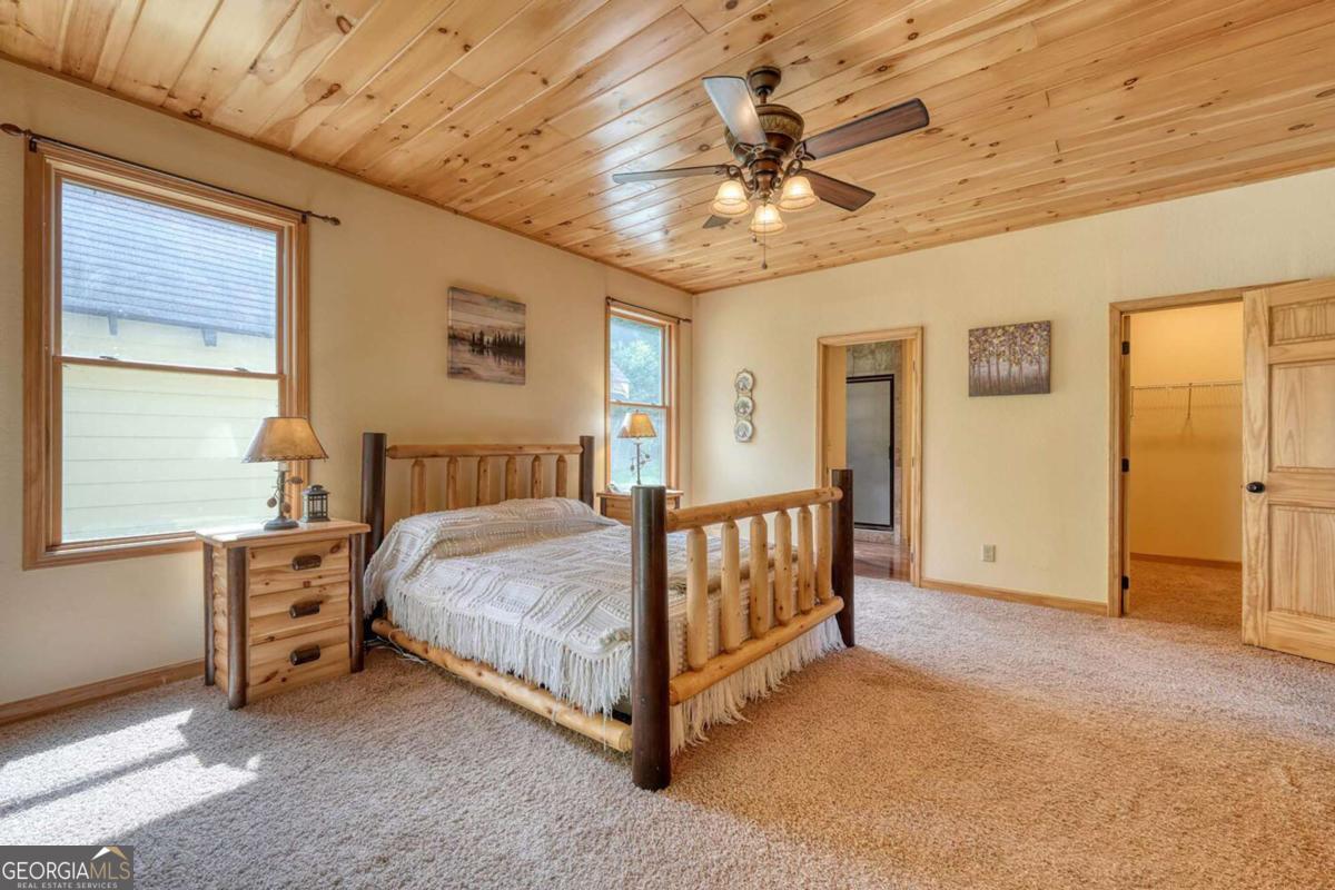 235 Oak Rdg Estate Murphy, NC 28906 - Photo 22 of 54 a spacious bedroom with a bed and a chandelier