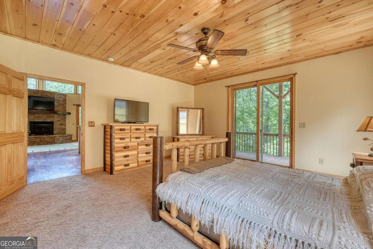 235 Oak Rdg Estate Murphy, NC 28906 - Photo 23 of 54 a bedroom with a large bed and a tv