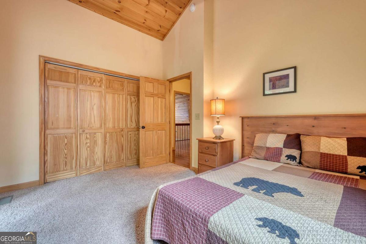 235 Oak Rdg Estate Murphy, NC 28906 - Photo 29 of 54 a bedroom with a bed and a chandelier