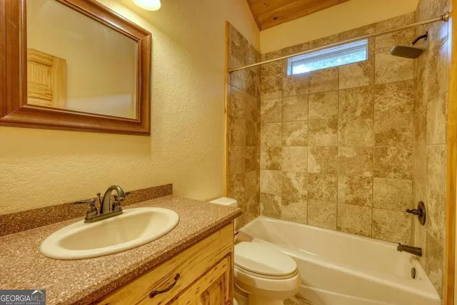 a bedroom with a large bed and a large window