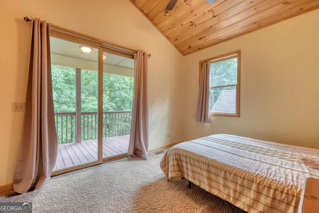 a view of a wooden deck next to a yard