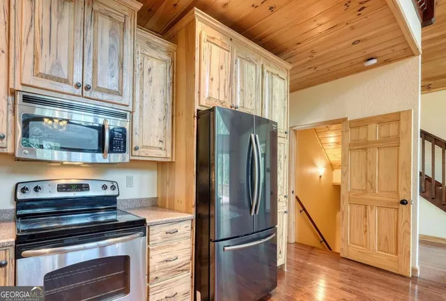 a view of empty room with a fireplace and windows
