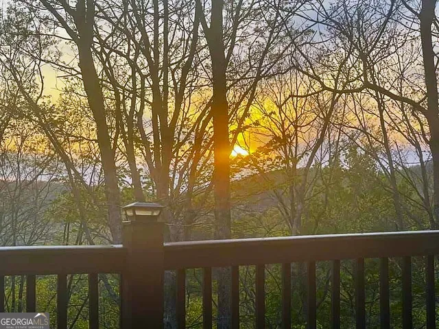 a view of a balcony with trees