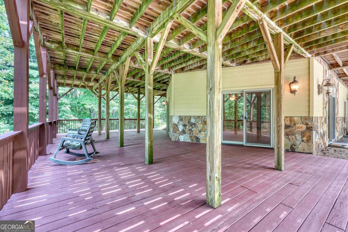 235 Oak Rdg Estate Murphy, NC 28906 - Photo 41 of 54 a view of a room with wooden floor and bench next to a yard