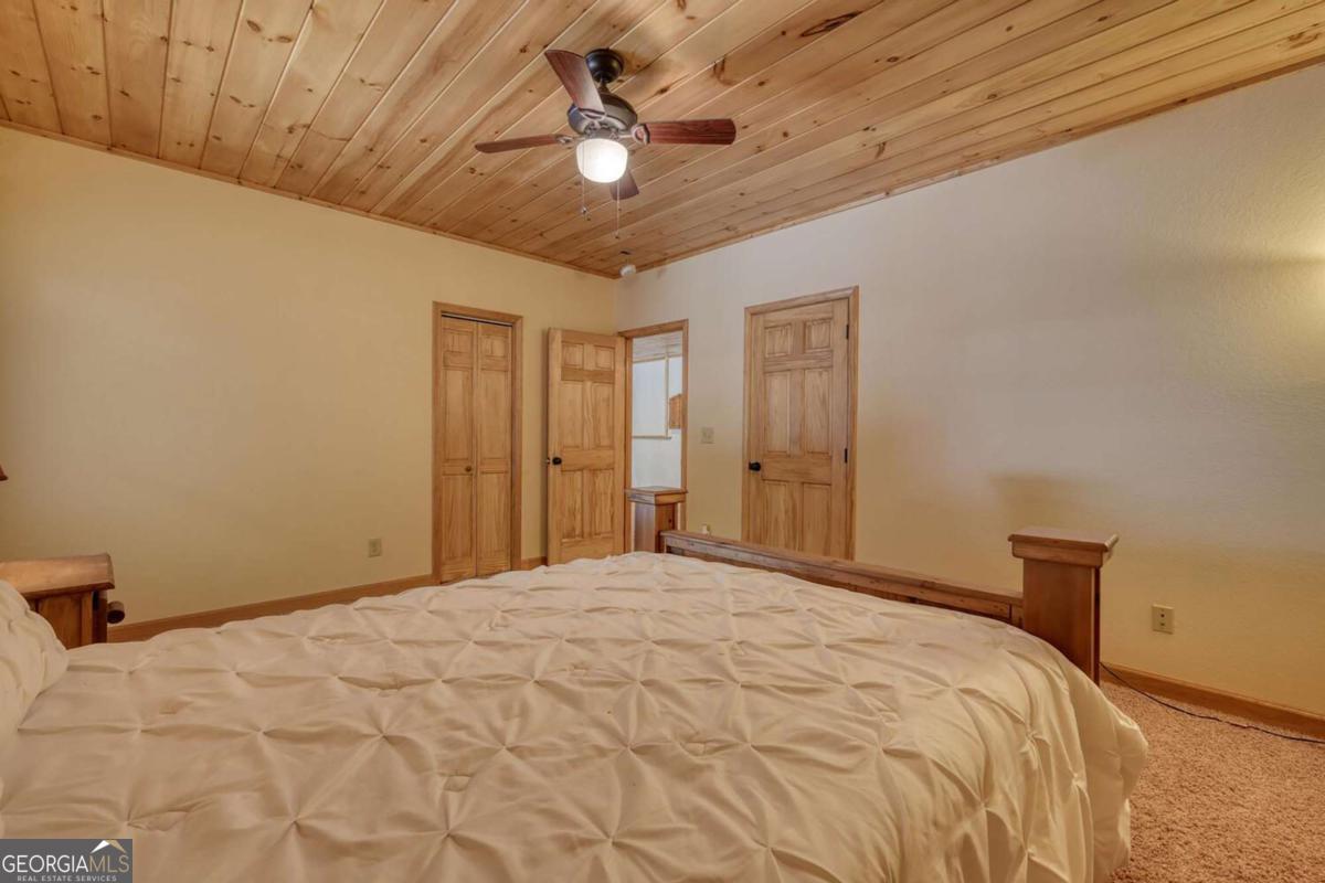 235 Oak Rdg Estate Murphy, NC 28906 - Photo 43 of 54 a bedroom with a bed and a chandelier