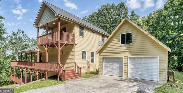 a view of backyard with a deck and wooden floor