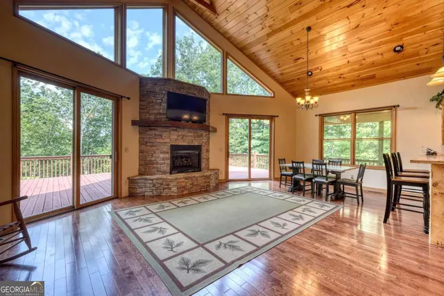 a living room with furniture large window and a fireplace