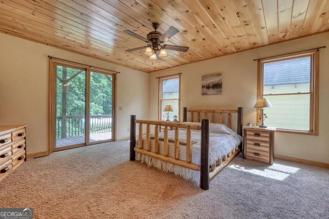a bed sitting in a spacious bedroom next to a window