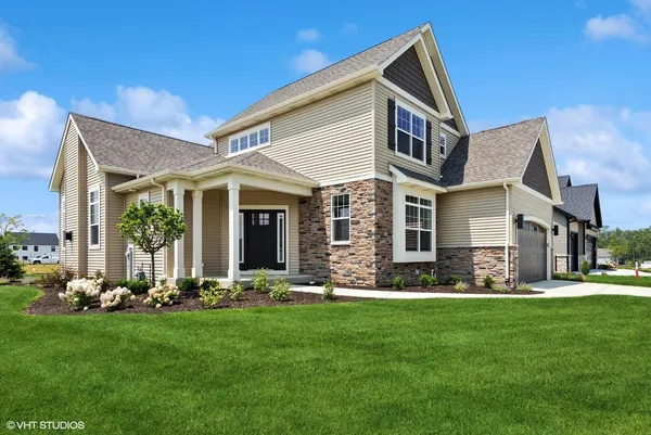 a front view of house with yard and green space