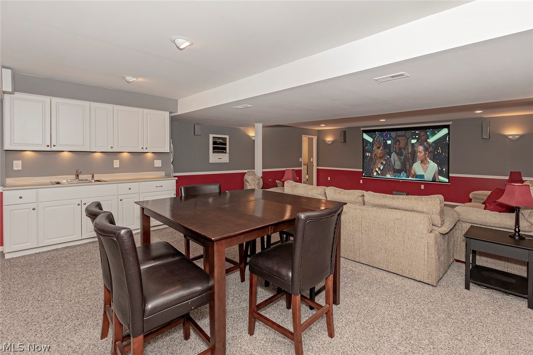 5420 Bartlett Road Bedford, OH 44146 - Photo 22 of 32 Entertainment space is an understatement for this enormous finished room. Projector, screen, fridge, sound system...all stay.