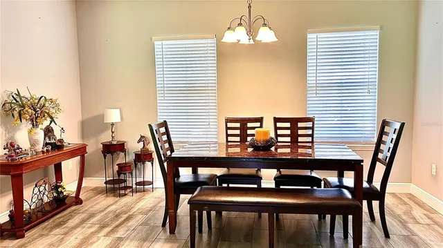 a dining room with furniture and wooden floor