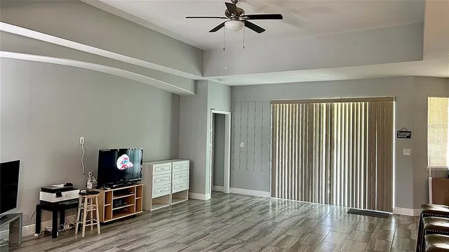 a view of a livingroom with wooden floor and furniture