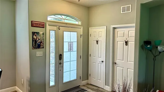 a view of front door with wooden door