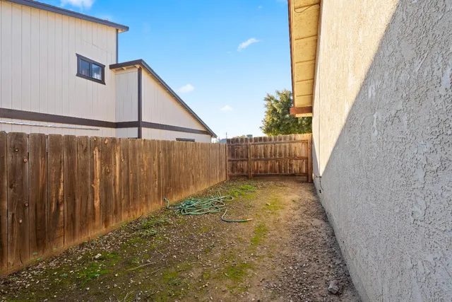 a view of a pathway of a building with wooden fence
