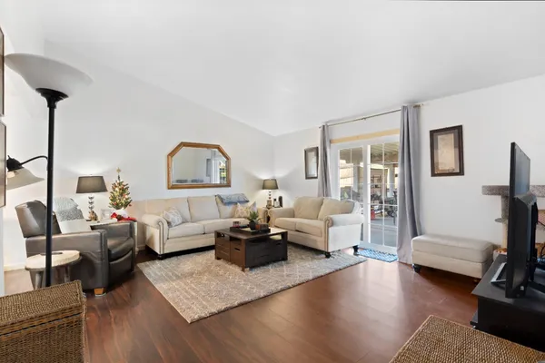 a living room with furniture or couch and a wooden floor
