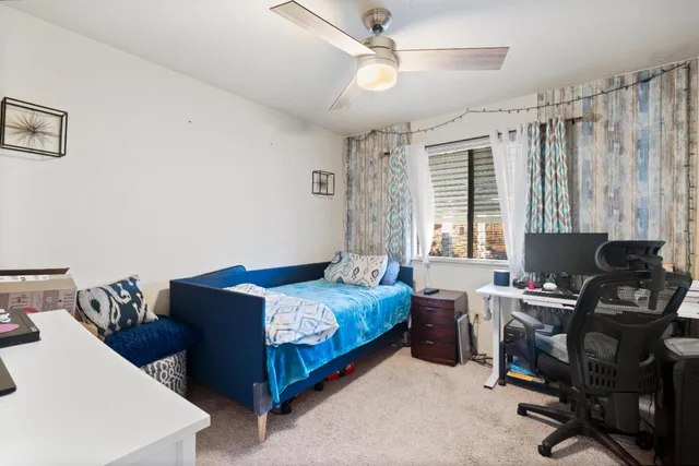 a bedroom with a bed and a window