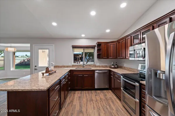 a spacious bathroom with a granite countertop sink and a mirror