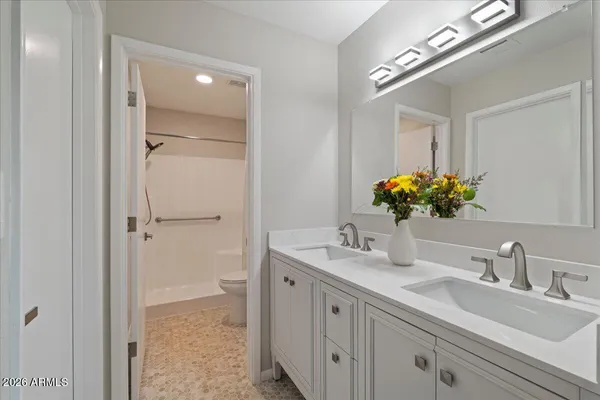 an empty room with window and ceiling fan
