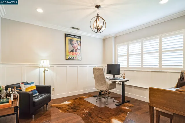 a view of a livingroom with workspace and a window