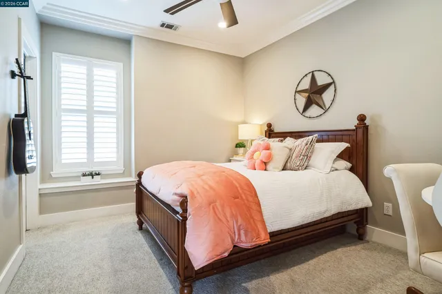 a spacious bedroom with a bed and a window