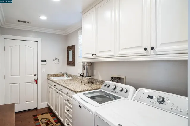 a kitchen with a sink cabinets and appliances