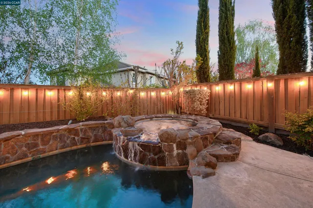 a view of a swimming pool with an outdoor space and seating area