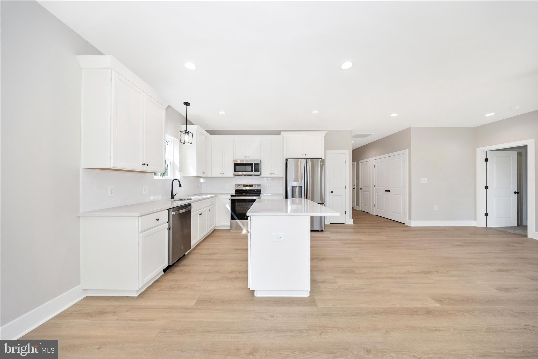 4 Fir Trail Fairfield, PA 17320 - Photo 11 of 53 a large white kitchen with a stove a sink dishwasher and a refrigerator with wooden floor