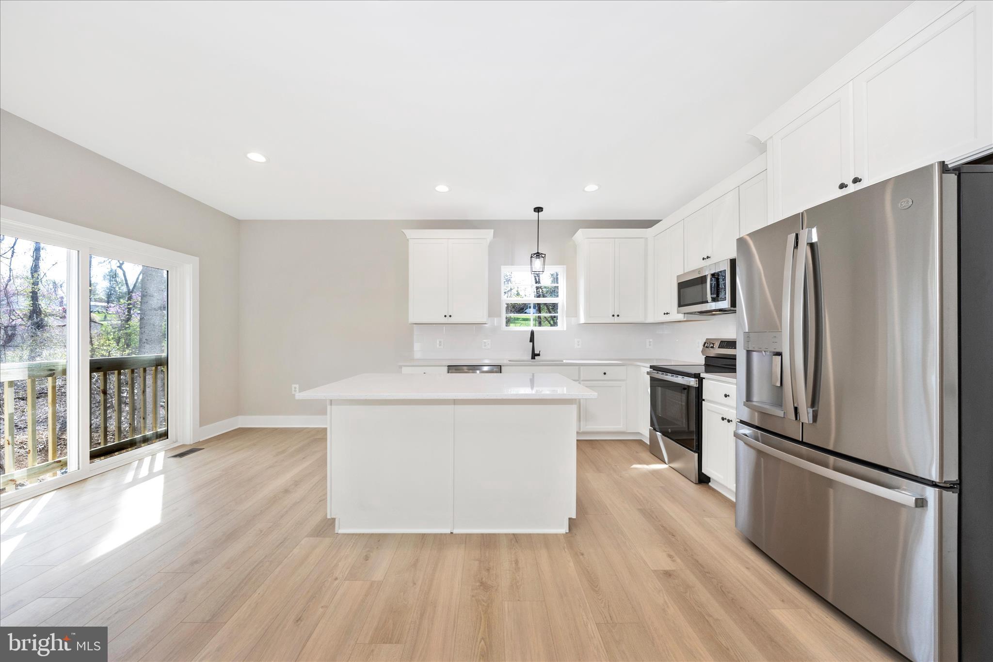 4 Fir Trail Fairfield, PA 17320 - Photo 9 of 53 a large white kitchen with a refrigerator a sink dishwasher a stove and a refrigerator with wooden floor