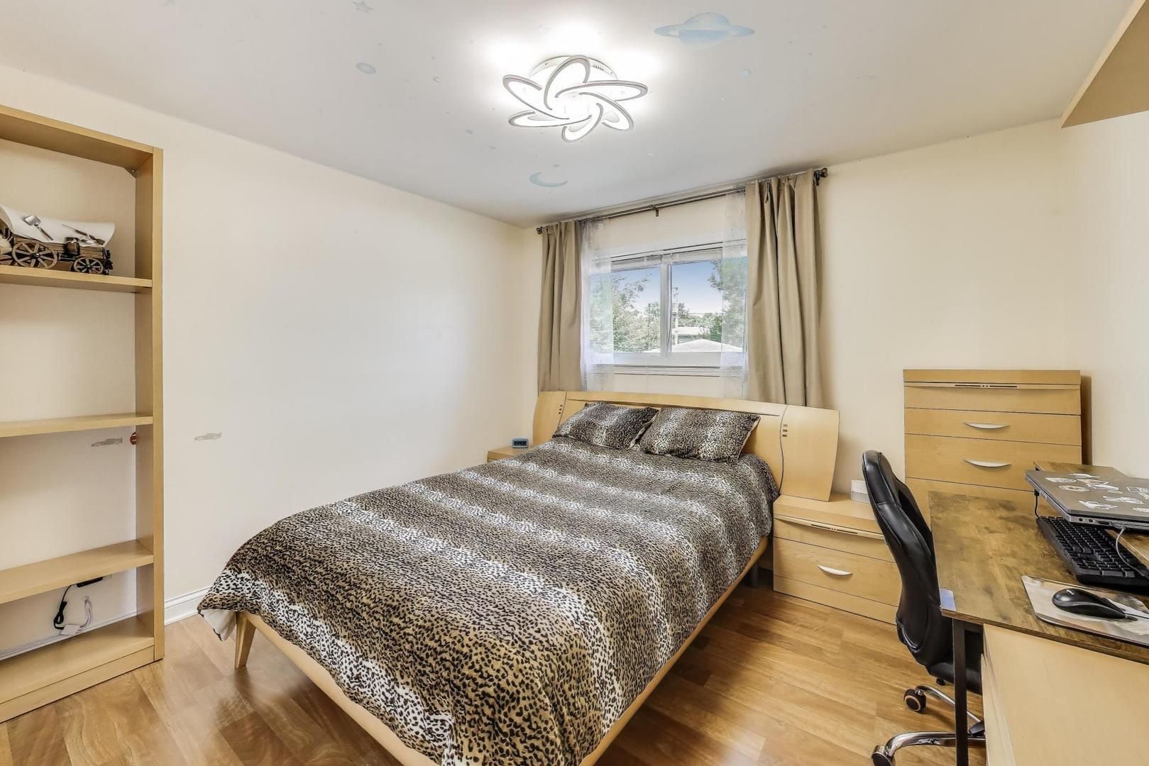 396 Stone Place Wheeling, IL 60090 - Photo 11 of 28 a bedroom with a bed and wooden floor