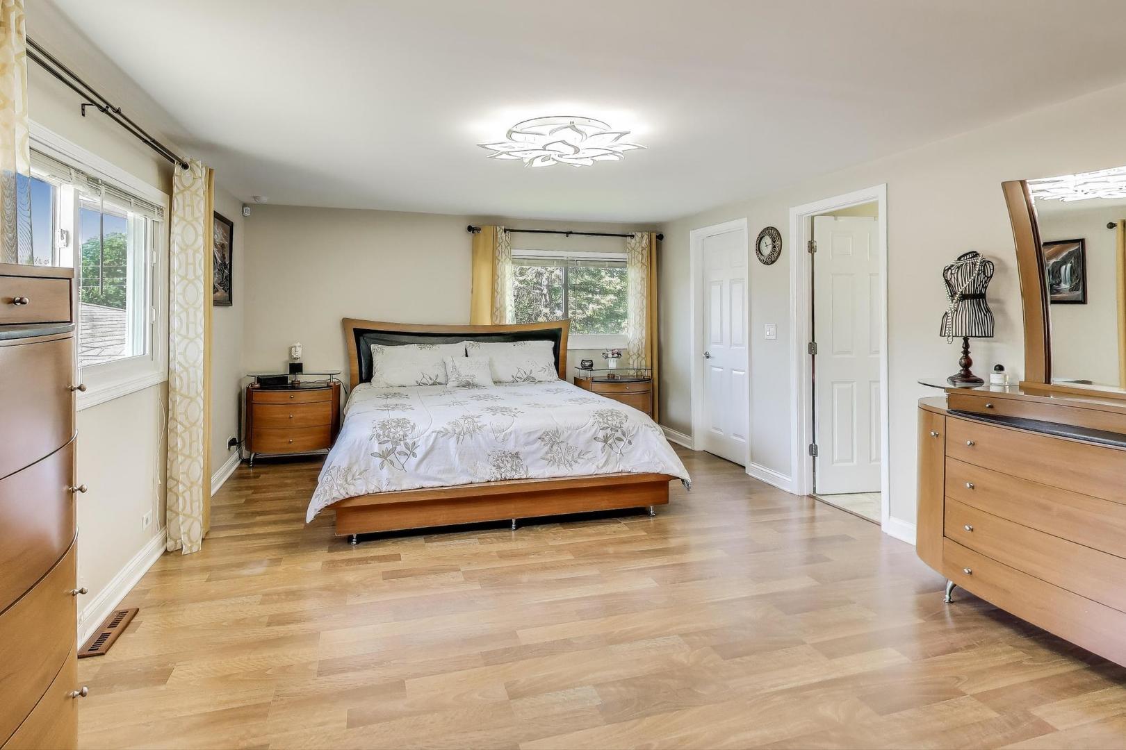 396 Stone Place Wheeling, IL 60090 - Photo 13 of 28 a bedroom with a large bed and a dresser