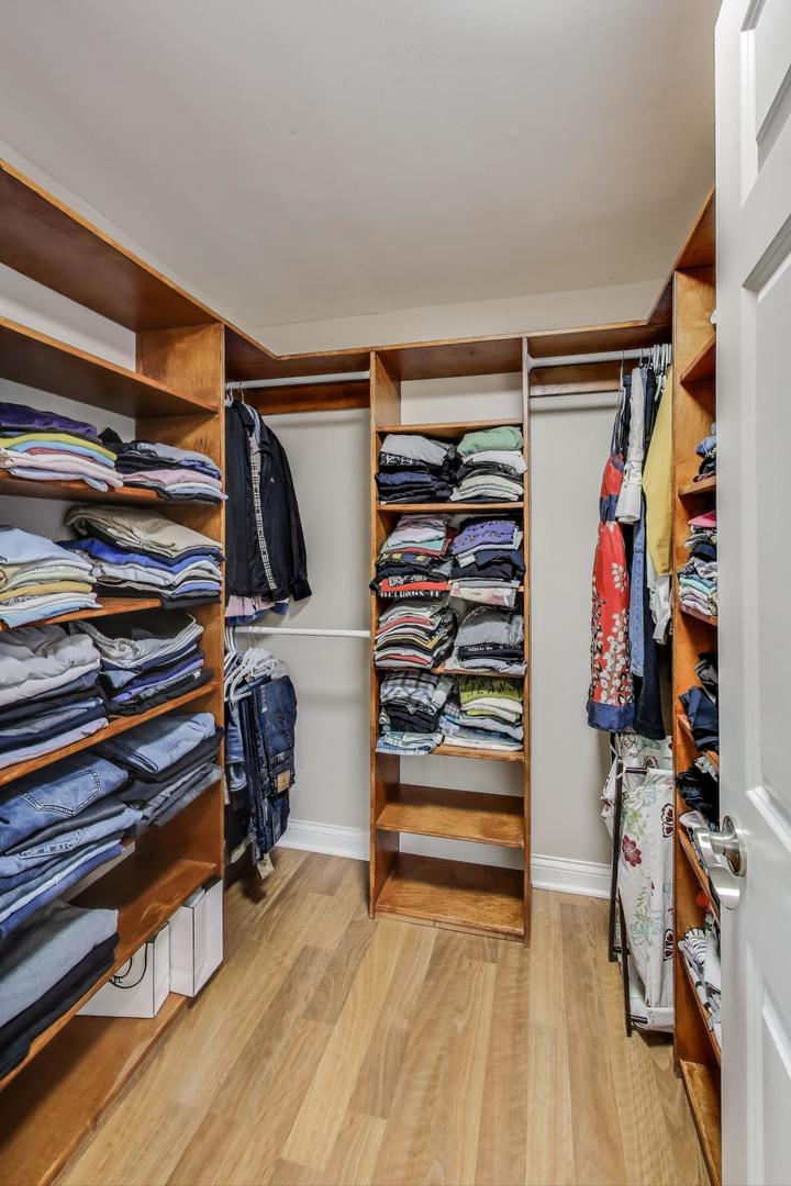 396 Stone Place Wheeling, IL 60090 - Photo 16 of 28 a view of walk in closet with clothes and shoes