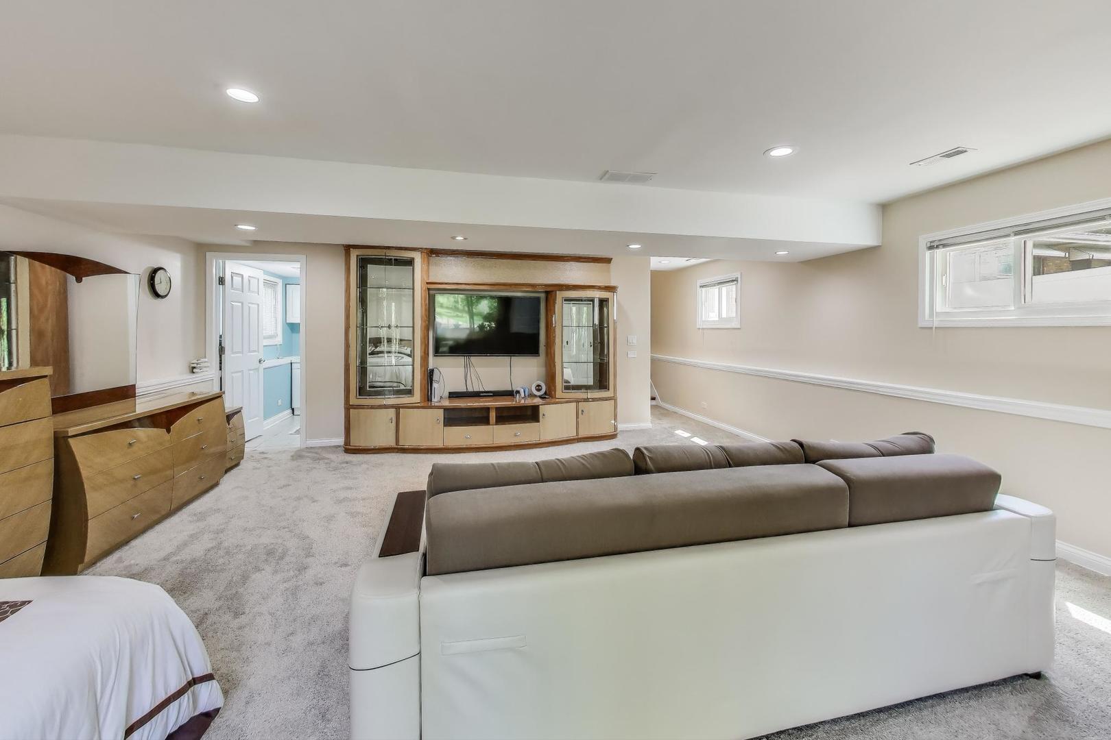 396 Stone Place Wheeling, IL 60090 - Photo 19 of 28 a living room with furniture and a flat screen tv