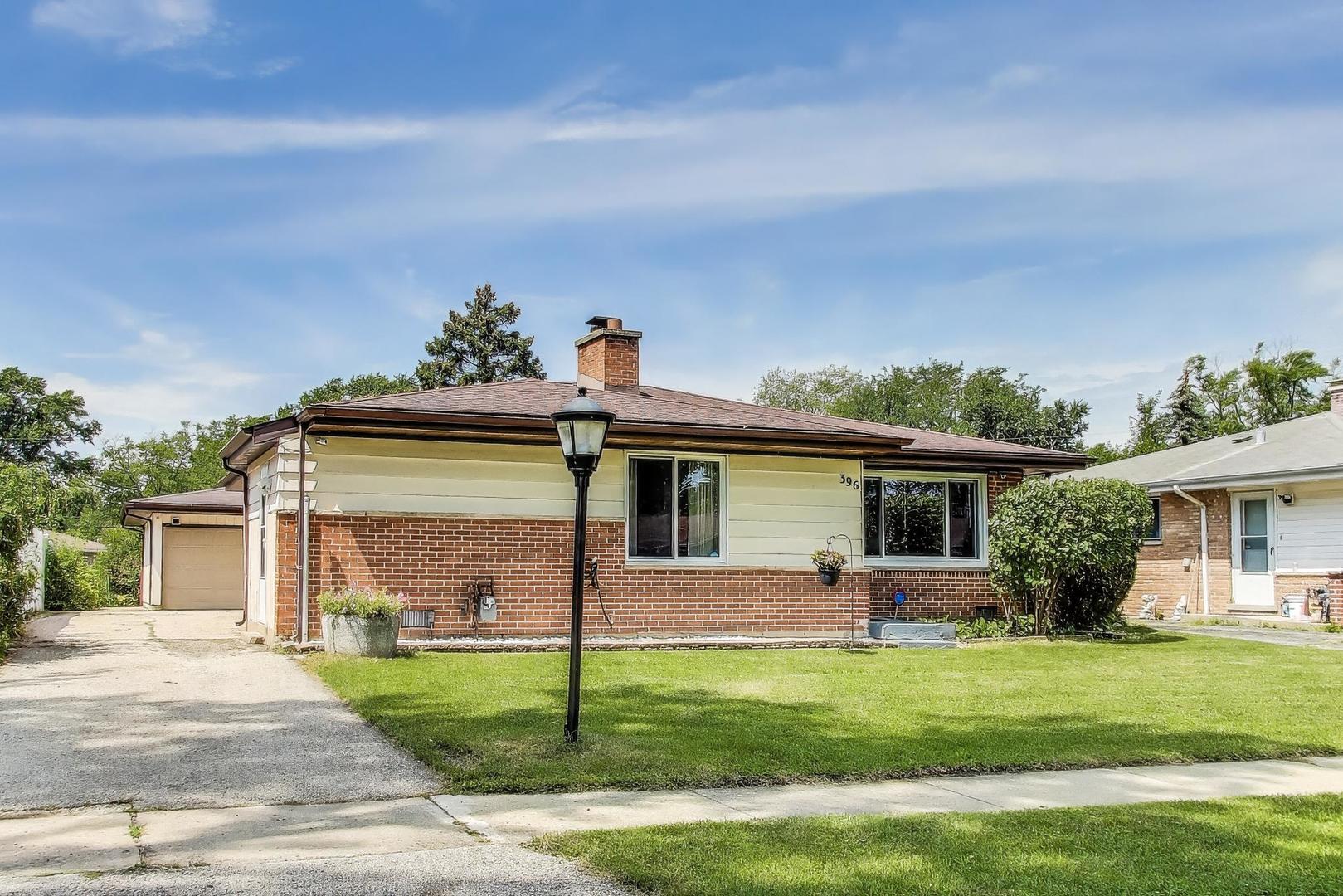 396 Stone Place Wheeling, IL 60090 - Photo 2 of 28 a front view of house with yard and green space