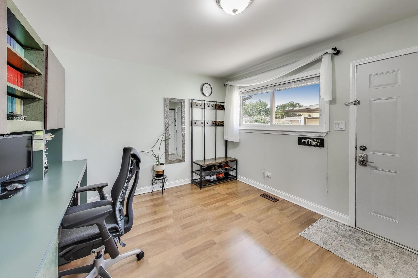 396 Stone Place Wheeling, IL 60090 - Photo 10 of 28 a view of a workspace with furniture and windows
