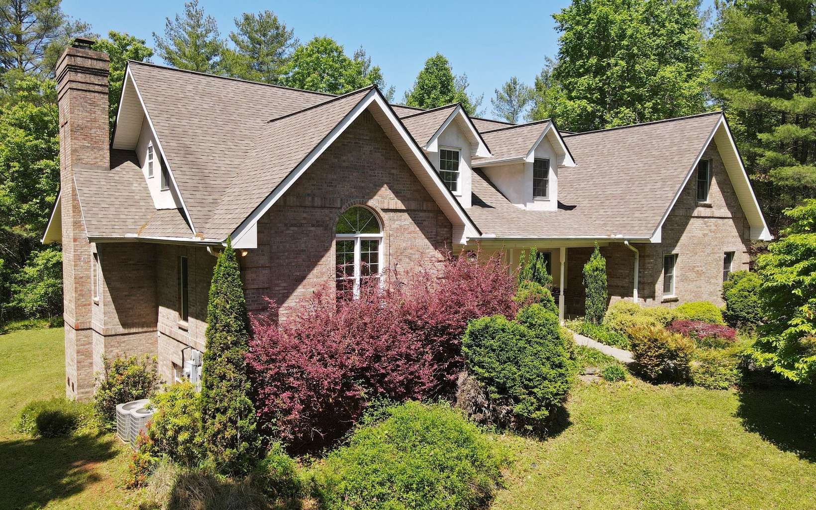 a aerial view of a house with a yard and potted plants