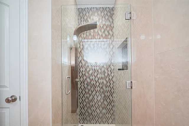 a bathroom with double vanity and a mirror