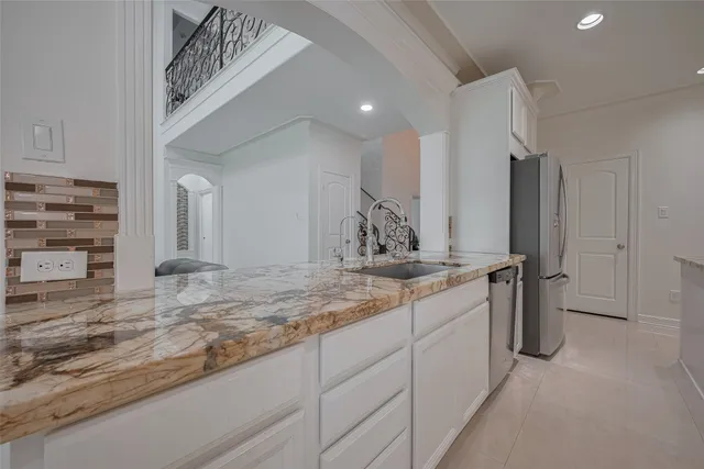 a kitchen with granite countertop cabinets and a stove