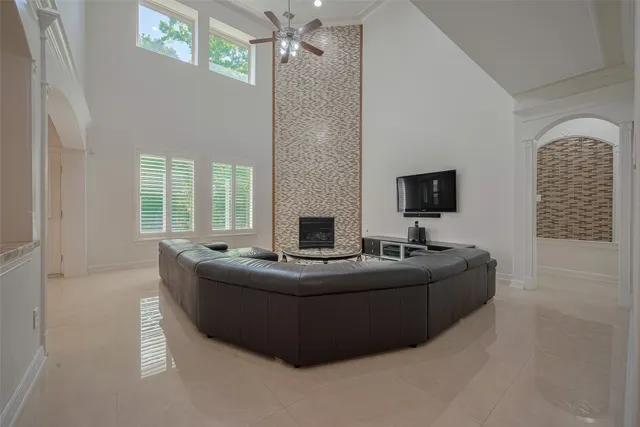 a bedroom with a large bed and a chandelier