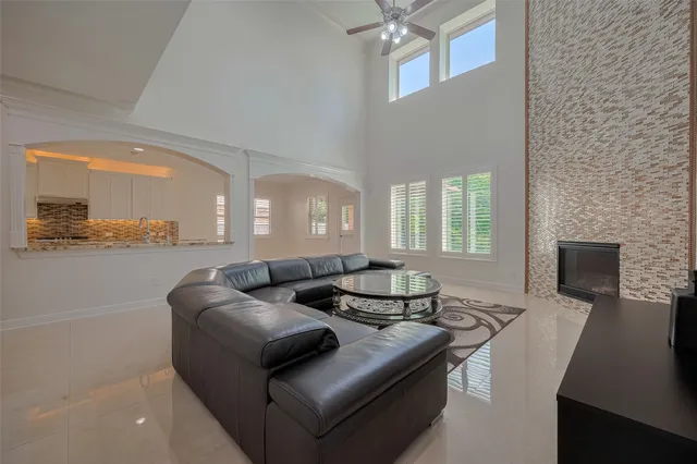 a spacious bedroom with a bed and a chandelier