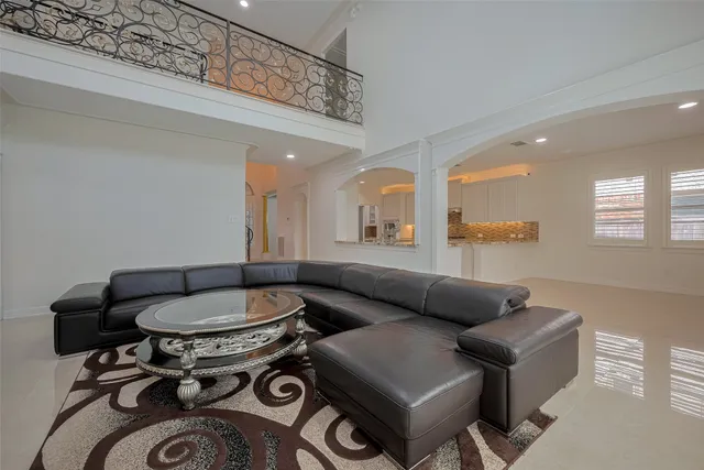 a large white kitchen with a large window appliances and cabinets