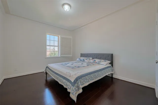 a view of a grassy field with trees in the background